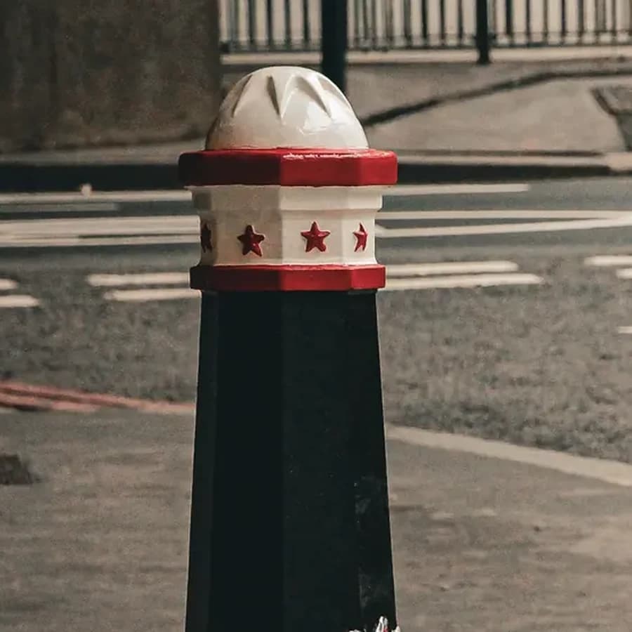 Decorative bollard cover with a domed cap and banded collar